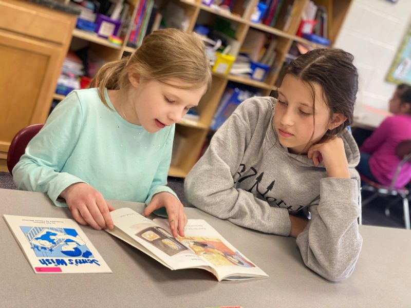 two students reading together